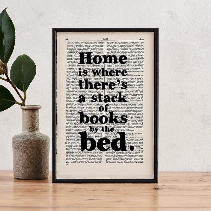 Bookishly 'Home is where there's a stack of books' Framed Book Page Print