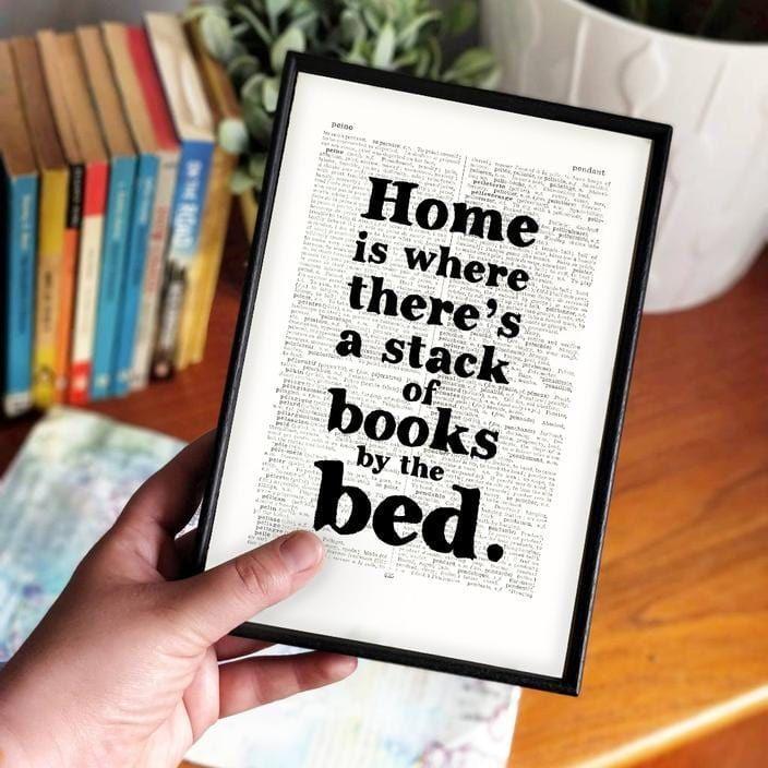 Bookishly 'Home is where there's a stack of books' Framed Book Page Print